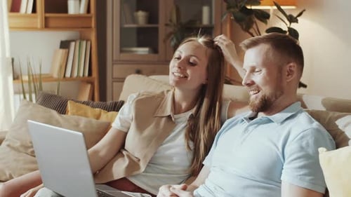 Couple Video Chatting on Laptop at Home