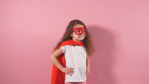 Young Girl Dressed as Superhero Points Upward