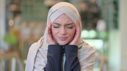 Woman in Hijab Experiencing Headache