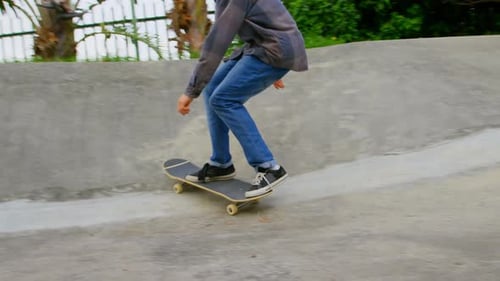 Front view of young caucasian man practicing skateboarding on ramp in skateboard park 4k
