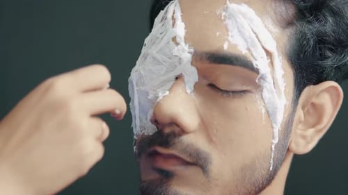 Male Model Getting Creamy Makeup Applied to Face