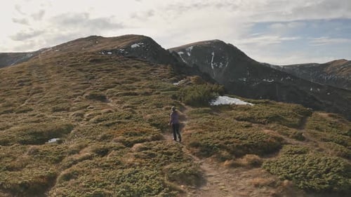 Woman Jogging at Sun Mountain Ridges