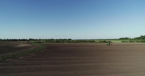 Tractor With A Plow Plowing In The Field