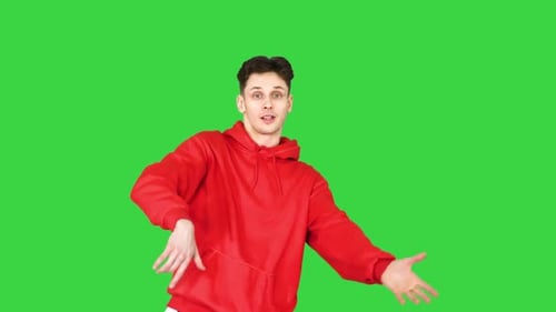 The Cute Young Man Telling a Story To the Camera on a Green Screen, Chroma Key.