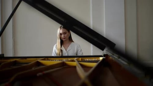 Woman Plays Classical Music on Grand Piano