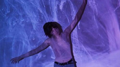 Woman Dancing in Front of Abstract Light Projection