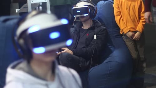 People In Virtual Reality Helmets Play On The Console