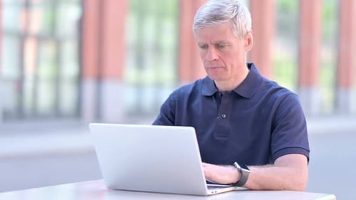 Adult Man Working on Laptop and Coughing