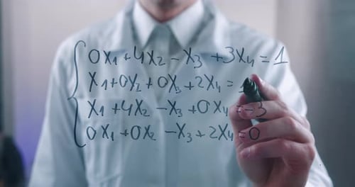 Man Writing Math Equations on Glass Board