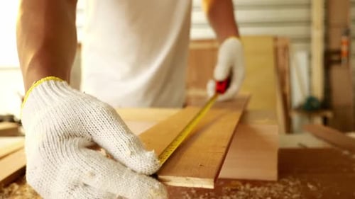 Woodwork and furniture making concept. Stylish craftsman working in his carpentry workshop