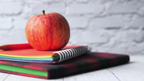 Back To School Concept with Apple on Stack on Notepad