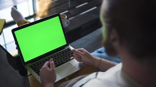 Unrecognizable Bearded Male Video Calling on Laptop with Green Screen