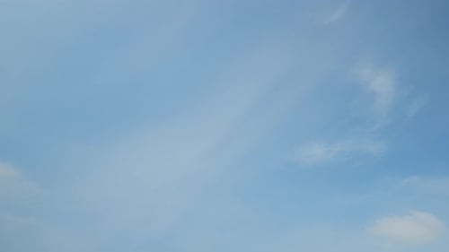 Fluffy White Clouds Drifting in a Blue Sky