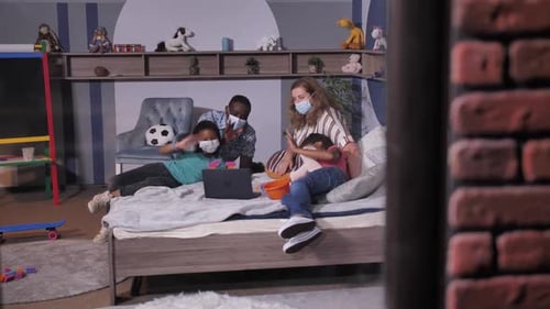 Family video calling on a laptop computer at home