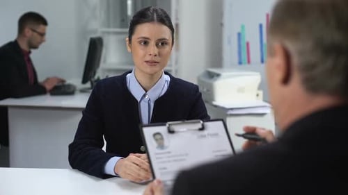 Hiring Manager Marking Resume of Unconfident Female Candidate, Hiring at Work