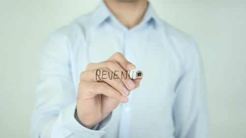 Writing Revenue Concept on Transparent Surface