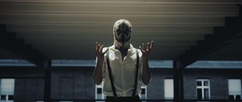 Masked Performer Standing with Hands Out