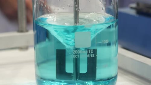 Mixing Turquoise Liquid in a Glass Beaker