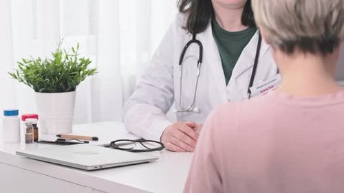 Medical Appointment in Clinic Office Patient Sits Down Doctor Starts Meeting