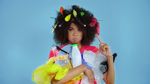 Woman holding plastic trash.