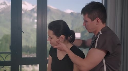 Manual Therapist Adjusting the Neck to Release Pain