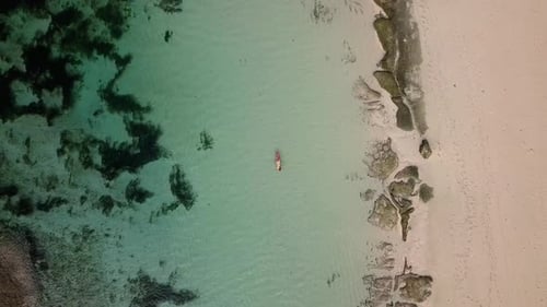 Woman Relaxing in the Sea on a Surfboard