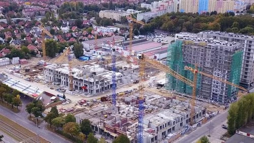 Construction of a residential building. Drone footage of construction site and cranes. Orbit shot. G