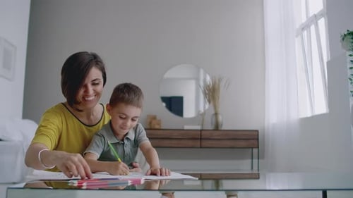 Mother and Son Drawing Together Indoors