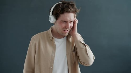 Man with Headphones Listening and Dancing to Music