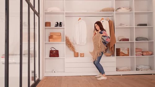 Stylish Woman Dancing While Choosing Clothes in Closet