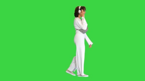 Beautiful Sporty African Girl Listening Music Headphones While Walking Green Screen Chroma Key