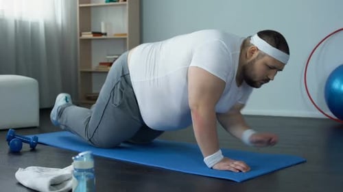 Bearded Adult Does Plank Exercise on Mat