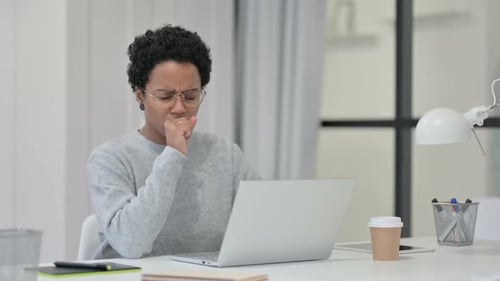 Woman Coughing While Working on Laptop