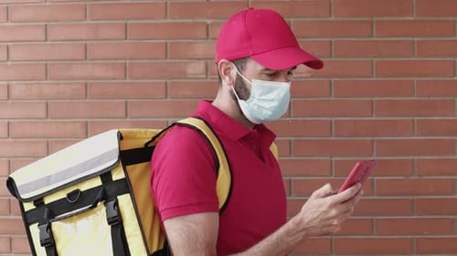 Delivery Driver Uses Phone in Urban Setting