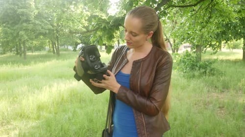 Woman Is Looking At A Virtual Reality Helmet In The Park