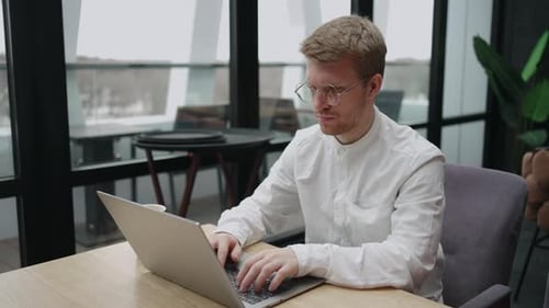 Programmer is Working with Laptop in Coworking Space or Office Typing Text on Keyboard Sending