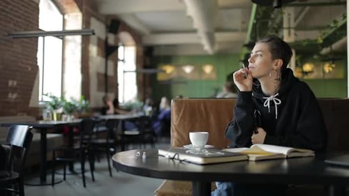 Thoughtful Girl Writing a Book