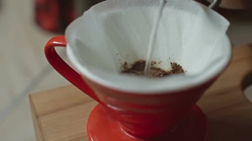 Water Pouring Into Coffee Filter With Coffee Grounds