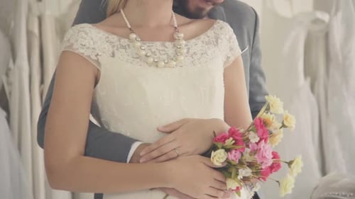 Romantic Wedding Couple Embrace in Bridal Boutique