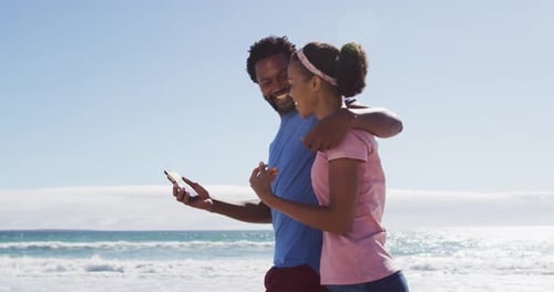 African american couple smiling taking selfie with smartphone on the beach