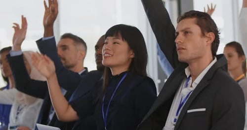 Attendees Raising Hands During Corporate Conference Session