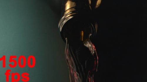 Wine Pouring Down From A Bottle Neck