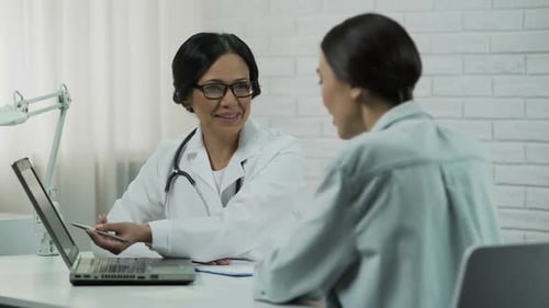 Doctor Consults with Patient in Medical Office