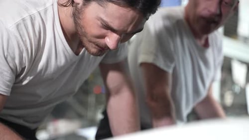 Mechanics Working on Car Engine in Garage