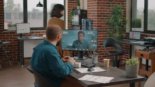 Man on Video Call in Urban Workplace