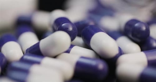 Medicine Pharmacy Concept - Extreme Close Up of Pills Rotating on Black Background