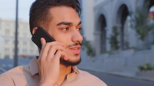Young Adult Man Talking on Phone in City