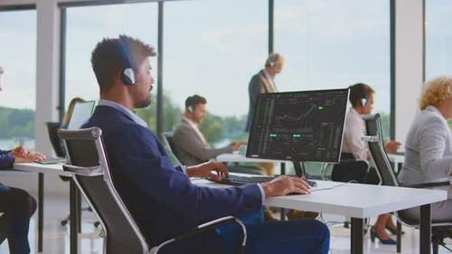 Modern Office Workers Analyzing Data with Headsets