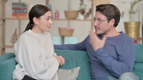 Couple Having a Conversation on the Sofa