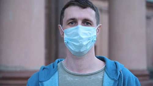 Portrait of a Young Man Wearing Protective Mask on Street